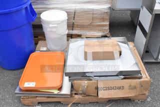 Brand new auction items including orange trays, white bucket, Flash Furniture MAT-124086-GG chair mats, and a cardboard box.
