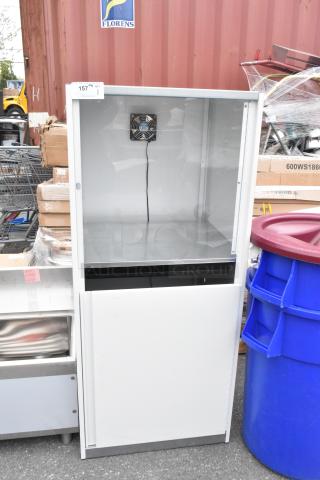 Brand new scratch and dent cabinet with fan installed, white finish, minor cosmetic flaws, suitable for storage or display.