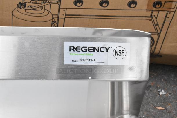 BRAND NEW Regency 600CDT24R 16 Gauge 2' Clean Dish Table, right drainboard, NSF certified, minor scratch visible.