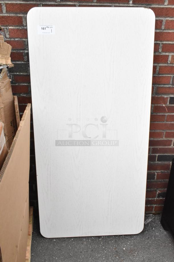 Brand new gray wood-pattern tabletop with minor scratches; rectangular shape. Label reads "161 QTY 1".