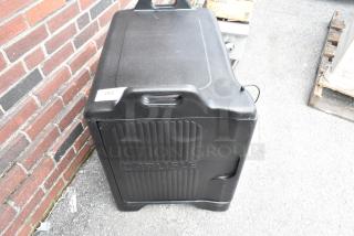 Carlisle black poly insulated food carrying case, brand new with minor scratches, dent visible, reinforced handles.