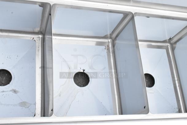 Brand new Steelton 522CS31620LR 3 bay stainless steel sink with dual drain boards, visible scratches and dents.