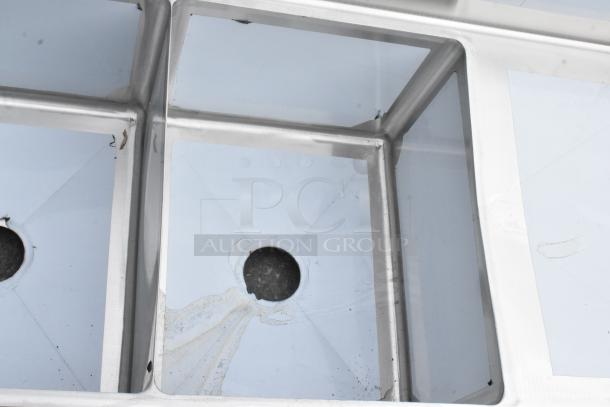 Stainless Steel 3 Bay Sink by Steelton with dual drain boards; new condition with minor scratches. Model 522CS31620LR.