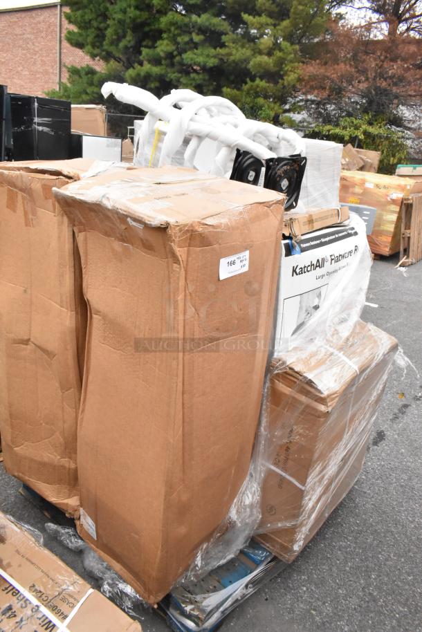 Stack of packaged auction items with visible KatchAll label, indicating scratch and dent condition. Various items included.