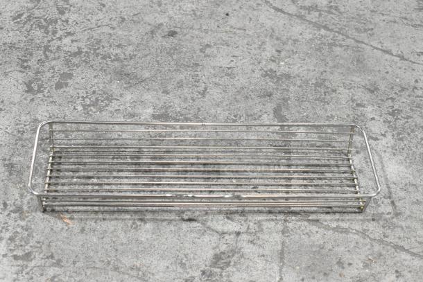 Metal basket with rectangular shape, open slatted design, used condition; part of a two-tier lot including various items.