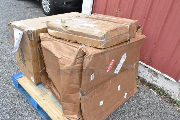 Four new scratch and dent boxes on pallet, containing a sink and fryer baskets, visible fragile and handling labels.