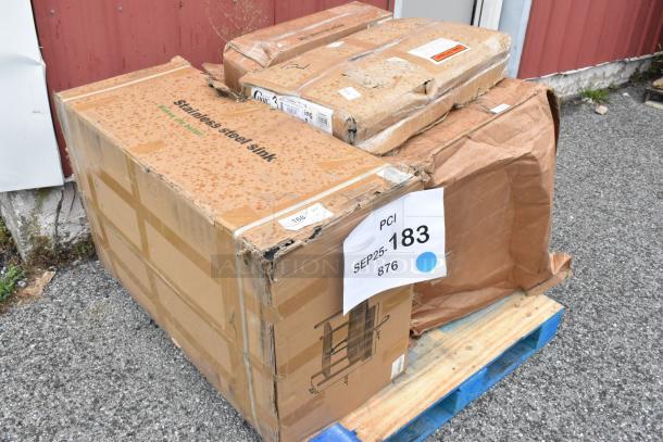 4 new scratch and dent boxes on a pallet. Marked "Stainless steel sink" and "fryer baskets." Tags indicate "PCI SEP25-183."