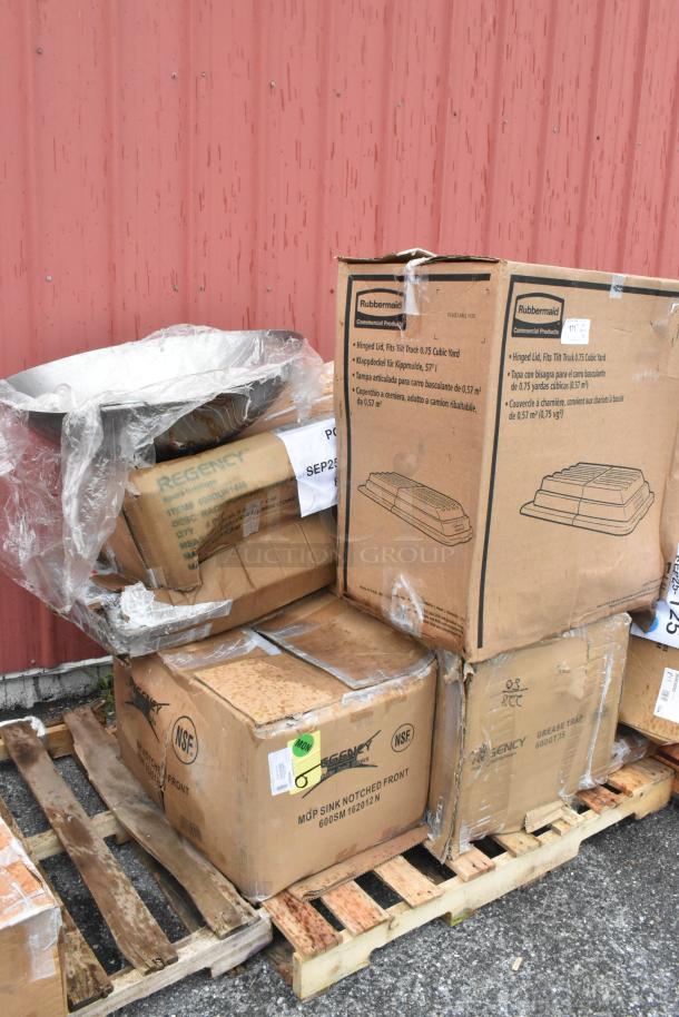 35 brand new scratch and dent boxes on pallets, including wok, Dunnage rack, and paper towel dispenser. Labels indicate Regency and Rubbermaid brands.
