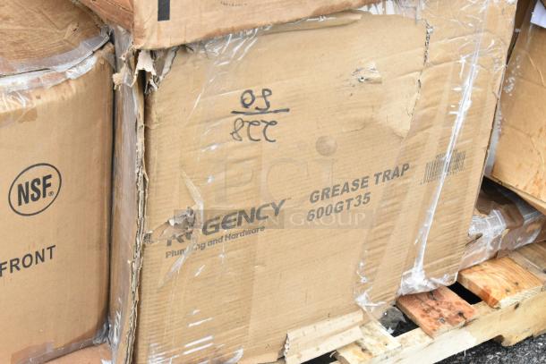 Damaged boxes labeled Regency 600GT35 Grease Trap on pallet; NSF mark visible.