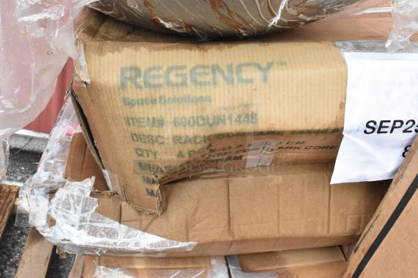 Boxes labeled "Regency Space Solutions" containing scratch and dent wok, dunnage rack, paper towel dispenser, new condition.