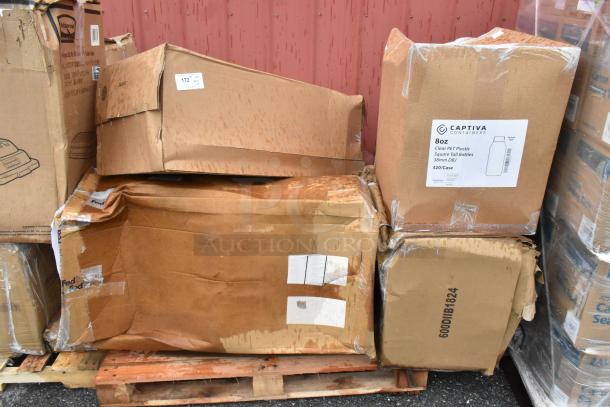 Five scratched and dented boxes on a pallet, containing a sink, work table, and Captiva juice bottles, marked 8oz PET plastic.