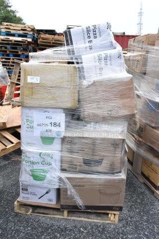 Pallet of 35 new scratch-and-dent boxes with plastic forks, sandwich wraps, plates, and T-shirt bags, wrapped in clear plastic.