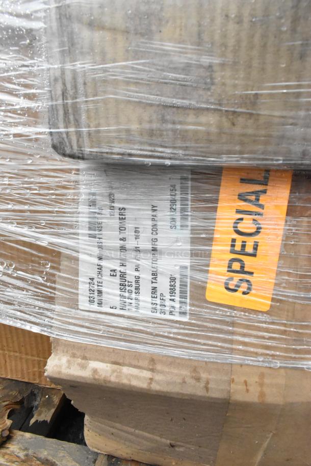 Pallet of new scratch and dent boxes wrapped in plastic, labeled "SPECIAL." Includes therapy bowls, plates, and pot brush.