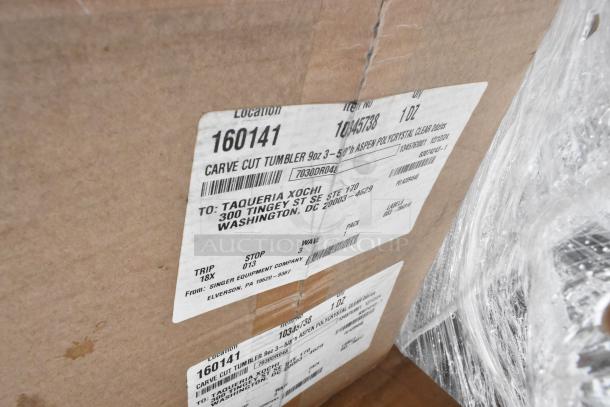 Cardboard box with shipping labels, item number 1045738, containing 9oz Aspen polycrystal tumblers. New condition.