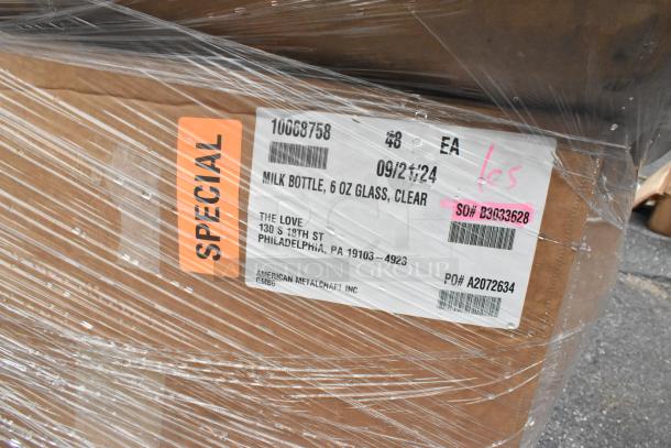 Pallet of 28 boxes labeled "Milk Bottle, 6 oz Glass, Clear," marked "Special." Wrapped in plastic, scratch and dent condition.