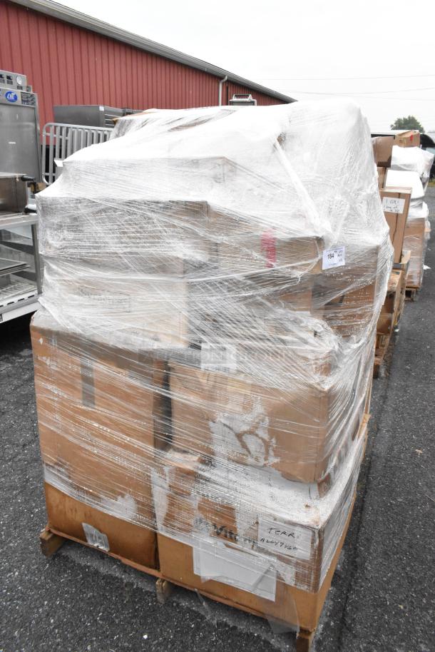 Shrink-wrapped pallet of 26 boxes labeled "scratch and dent," containing bowls, napkins, ramekins, stock pot, and champagne flutes.