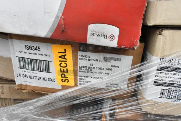 Boxes labeled for napkins and tableware, marked "SPECIAL," wrapped for auction, brand logos visible.