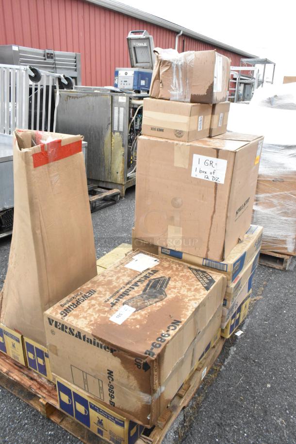 21 new scratch and dent boxes on pallets containing coffee mugs, pizza peels, and plastic pourers, some with labels.
