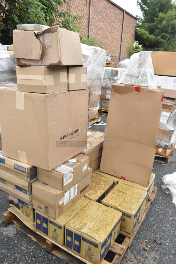 21 brand new scratch and dent boxes containing coffee mugs, pizza peels, and plastic pourers, stacked on pallets.