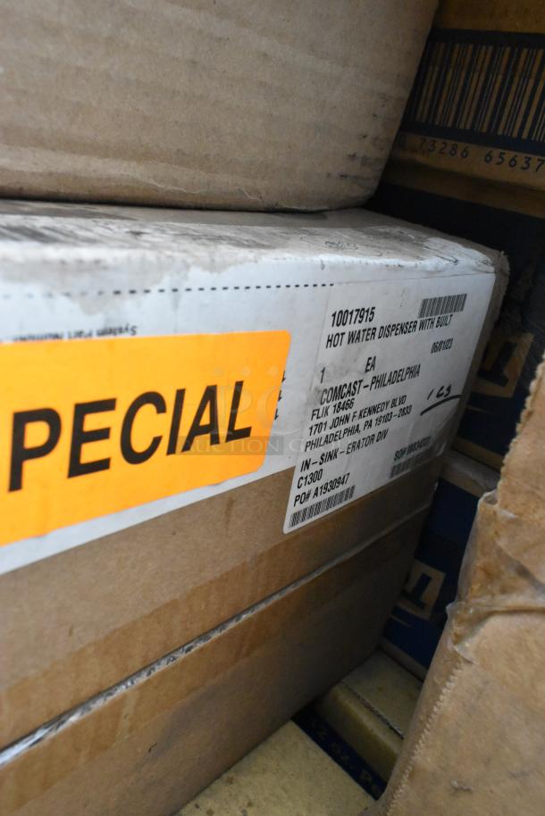 Auction items, brand new scratch and dent boxes, featuring hot water dispenser, label shows details and "SPECIAL" tag.