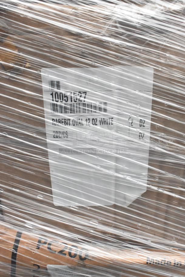 Plastic-wrapped pallet with label "10051827 RAREBIT OVAL 12 OZ WHITE 2 DZ/CS." Contains scratch and dent items, including plates.