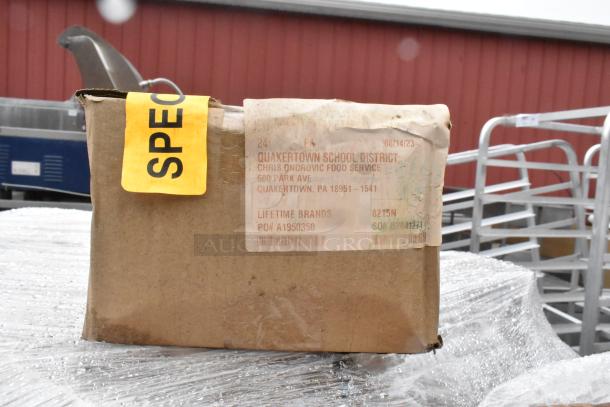 Cardboard box labeled "SPECIAL" and "Lifetime Brands," from Quakertown School District. Box is damp with visible wear.