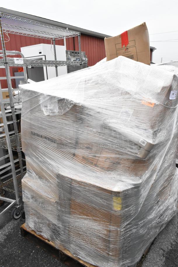 Large pallet of wrapped boxes, containing new scratch and dent items like plates, glasses, knives, and cups.