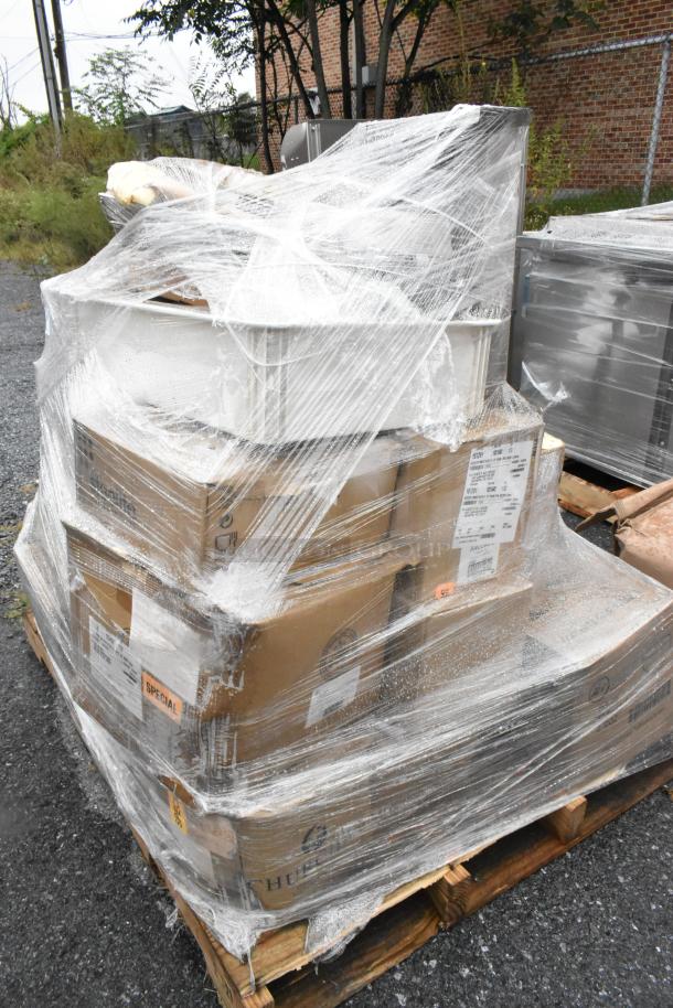 Shrink-wrapped pallet with 27 scratch and dent boxes containing plates and bowls, visible labels and special tags.