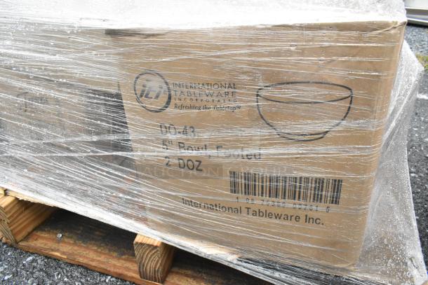 27 new scratch and dent boxes on a pallet, including International Tableware bowls and plates. Visible brand markings.