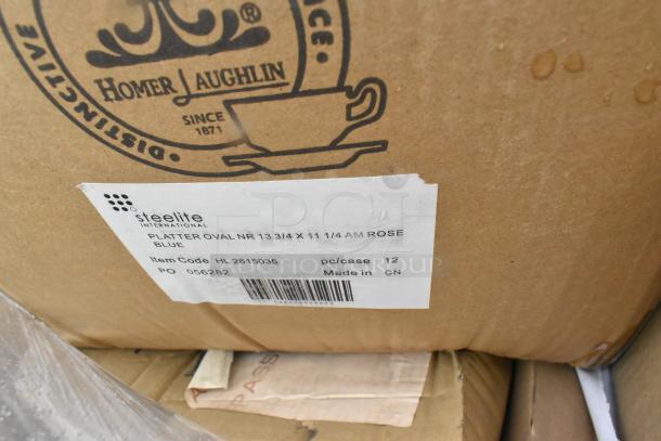 Cardboard box labeled "Homer Laughlin" and "Steelite International," containing 12 oval platters, 13 3/4 x 11 1/4 inches, made in China.
