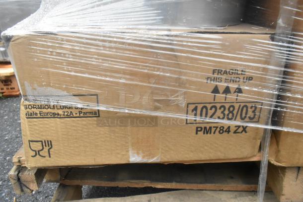 Pallet of 18 scratch and dent boxes with visible labels, including "Bormioli Luigi S.P.A, Parma." Contains heat lamp and dispenser.