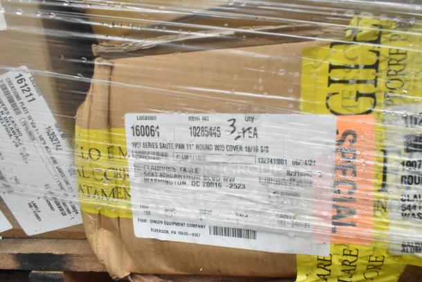 Plastic-wrapped boxes with labels; 52 scratch and dent items including plates, bowls, dispenser. Marked as 1997 Series Sauté Pan.