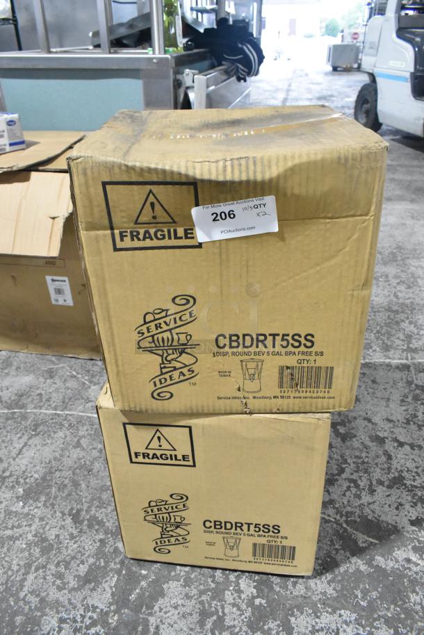 "Two boxes of Service Ideas 5 gal Beverage Dispenser with Infuser & Ice Tube, new scratch and dent. Fragile labels visible."