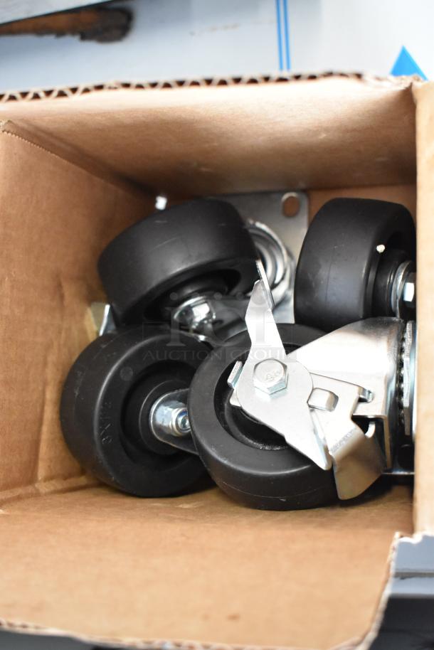 Box of caster wheels for a Beverage Air WTFCS36HC chef base, showing multiple black wheels with metal brackets.