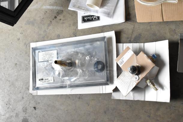 Brand new Perlick DDS36 stainless steel kegerator components, including a tap and fittings, still in packaging.