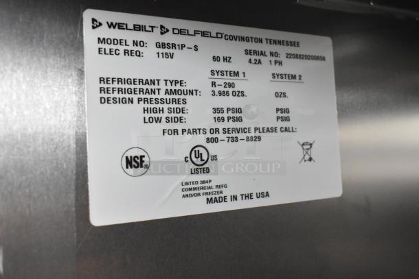 Delfield GBSR1P-S stainless steel commercial cooler label showing model, voltage, refrigerant details, and certifications.