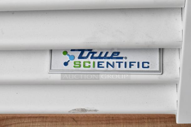 "True Scientific" logo on the BRAND NEW 2025 True TSCI-600R-G-PH commercial cooler with minor scratches.