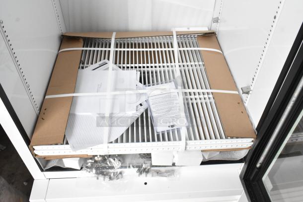 Brand new 2025 True TSCI-600R-G-PH reach-in cooler merchandiser with poly-coated racks, 115V, 1 phase; packaging and documents included.