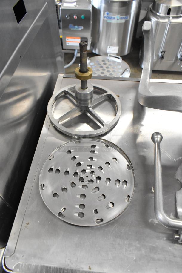 2021 Precision HD-60 commercial dough mixer accessories, including a metal mixing blade and disc, shown on a steel surface.