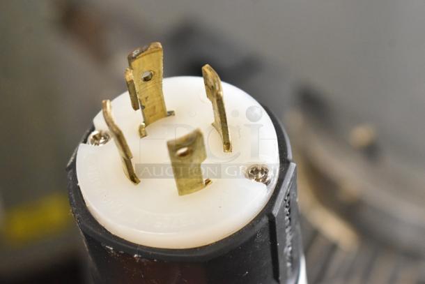 Close-up of a plug for the 2021 Precision HD-60 60-Quart Dough Mixer, highlighting the connector pins for 220V, 3-phase power.
