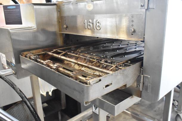 Turbochef HhC2020 stainless steel conveyor pizza oven on casters, commercial electric, visible gear mechanism and label details.