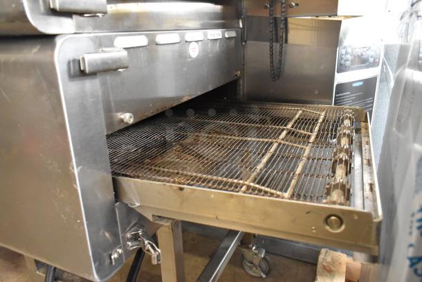 Turbochef HhC2020 stainless steel conveyor pizza oven on commercial casters, electric-powered, 208/240V, used condition.