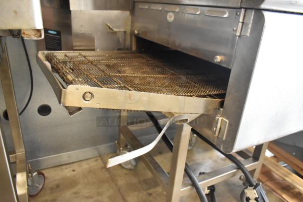 Turbochef HhC2020 stainless steel electric pizza oven with conveyor, commercial casters, 208/240V, 1 phase, used condition.