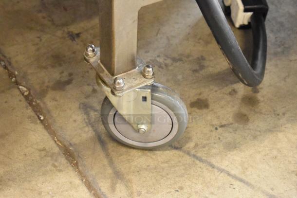 Sturdy caster wheel on the Turbochef HhC2020 conveyor pizza oven. Durable stainless steel construction.