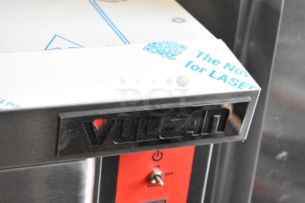 Brand new Vulcan VC4GD-11D150K stainless steel convection oven, view-through doors, metal racks, thermostatic control.