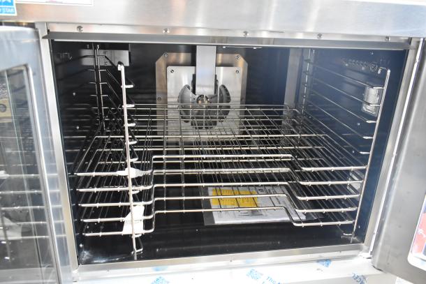 Brand new Vulcan VC4GD-11D150K stainless steel convection oven with view-through doors, metal racks, and thermostatic controls.