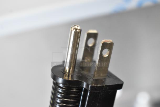 Close-up of a metal plug tip for a Vulcan oven, showing three prongs and part of the black casing.