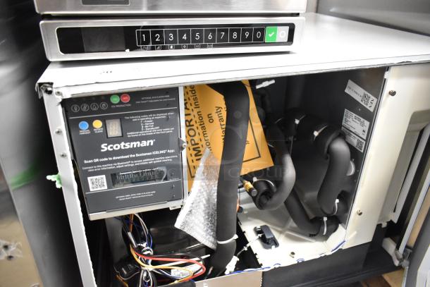 Stainless steel Scotsman MC0330SA-1A commercial ice machine, new with scratches and dents, 115V, visible interior components.