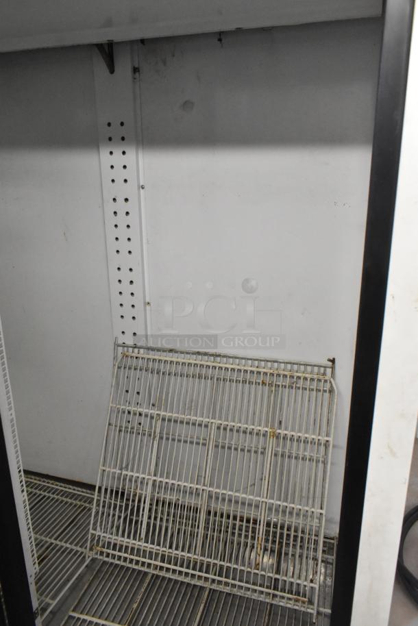 Turbo Air TGM-48R commercial cooler interior, showing poly coated racks. Slight wear visible on metal surfaces.