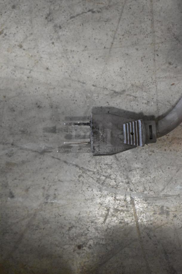 Turbo Air TGM-48R commercial cooler power plug, visible against a concrete floor, indicating use. 115 Volts, 1 Phase.